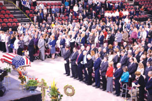 May 6 funeral for Sen. Conrad Burns at MetraPark drew a crowd of dignitaries and elected officials, including Gov. Steve Bullock, Montana's Congressional delegation, former Wyoming Sen. Alan Simpson and his wife of Cody, former U.S. Rep. Denny Rehberg and former Gov. Marc Racicot, all shown in the front row at right. Burn's family is in the front rows at left. (Judy Killen photo) 