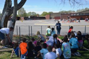 Nic Talmark, Chairman of the Lockwood Pedestrian & Safety District talking to students Wednesday May 4th about Lockwood Bike Safety week while Yellowstone County Commissioner Bill Kennedy watches in the background. 